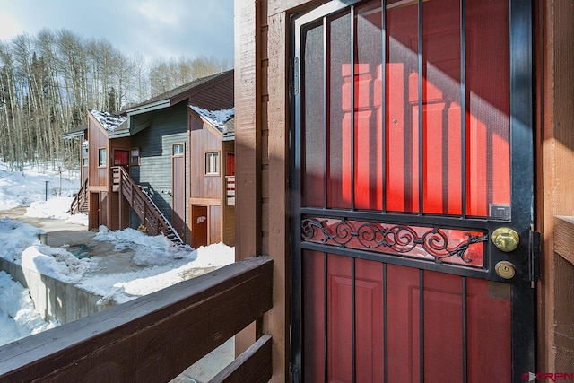 view of snow covered property entrance