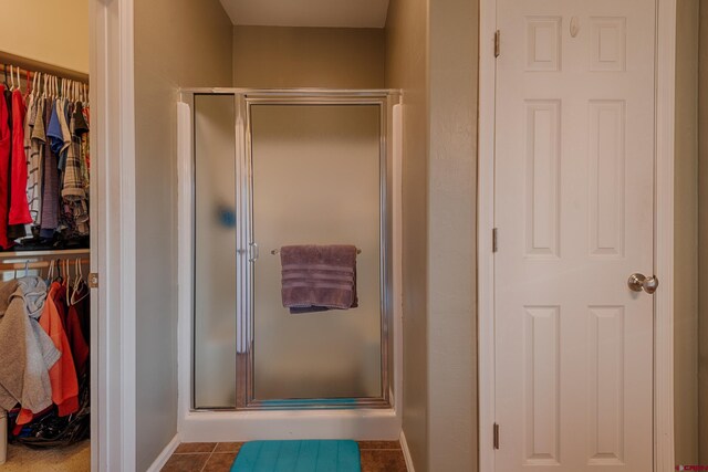 bathroom with tile patterned floors and walk in shower