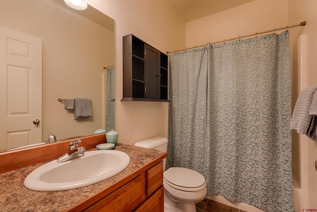 bathroom featuring tile patterned flooring, vanity, and toilet