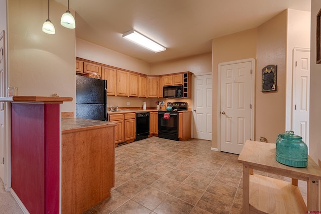 kitchen featuring sink, hanging light fixtures, and black appliances