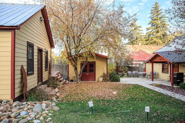 view of yard with an outdoor structure and a patio