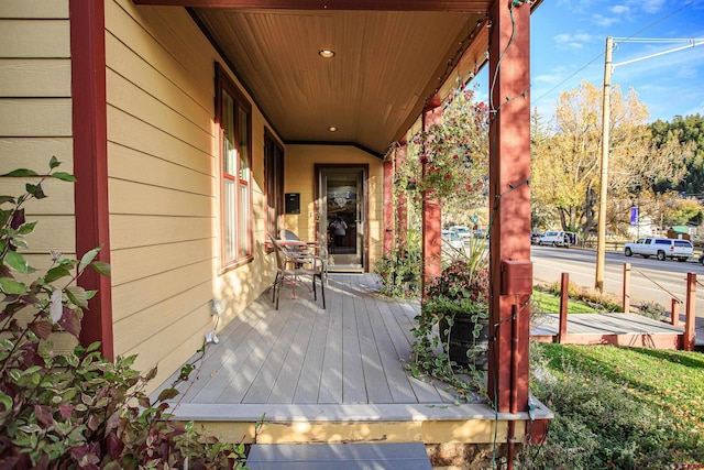 wooden terrace with a porch