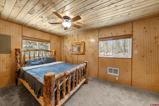 carpeted bedroom featuring wooden walls, electric panel, ceiling fan, and wooden ceiling