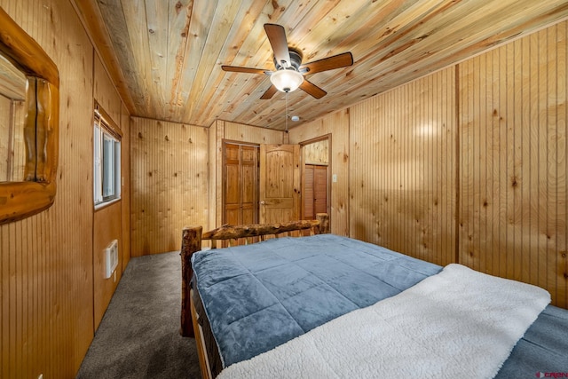 bedroom with carpet, ceiling fan, wooden walls, and wood ceiling