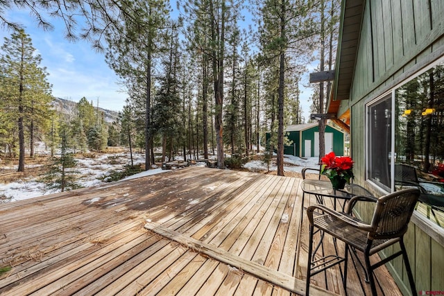 snow covered deck with an outdoor structure