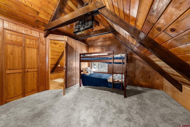 unfurnished bedroom featuring carpet flooring, wooden walls, and wood ceiling