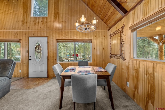 dining area with a healthy amount of sunlight, vaulted ceiling, a notable chandelier, and wood ceiling