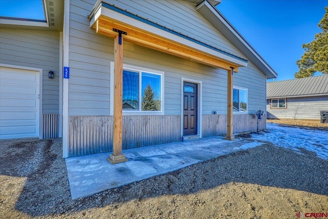 doorway to property with a garage