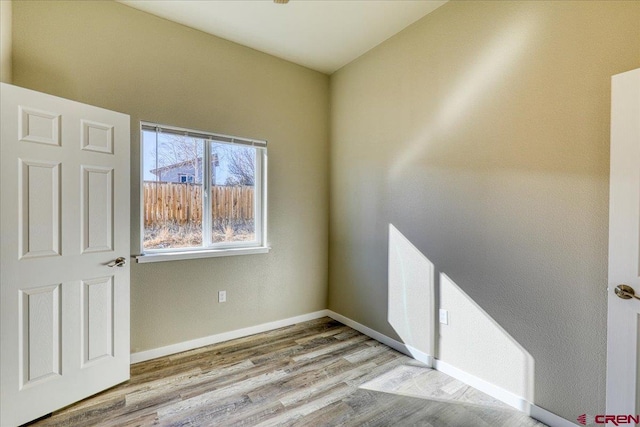 empty room with light hardwood / wood-style floors