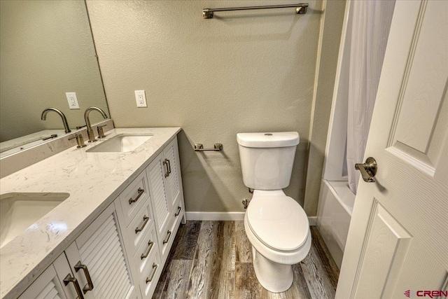 full bathroom with vanity, toilet, wood-type flooring, and shower / bath combo