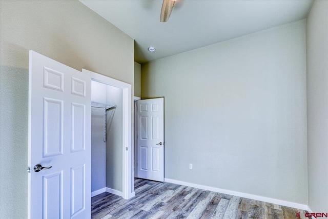 unfurnished bedroom featuring a closet, light hardwood / wood-style flooring, and ceiling fan