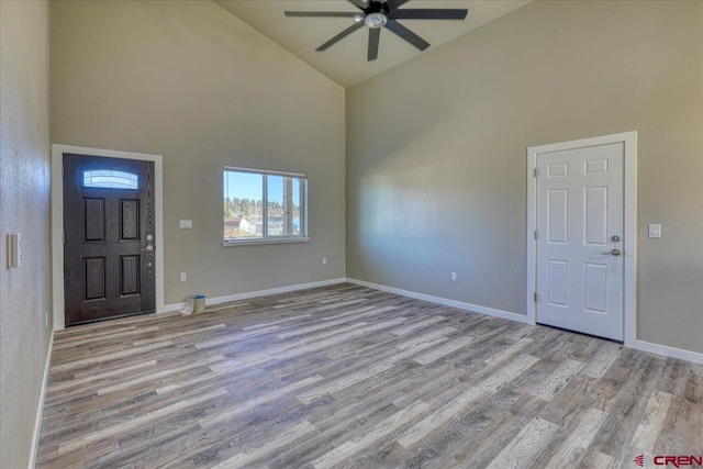 entrance foyer featuring ceiling fan, high vaulted ceiling, and light hardwood / wood-style flooring