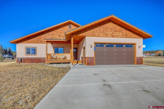 view of front of property with a porch and a garage