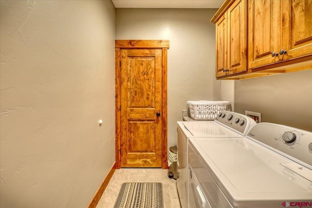 washroom with washing machine and clothes dryer, light colored carpet, and cabinets