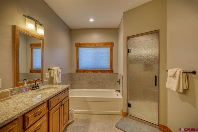 bathroom featuring vanity and separate shower and tub