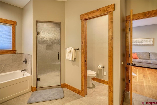 bathroom with toilet and shower with separate bathtub