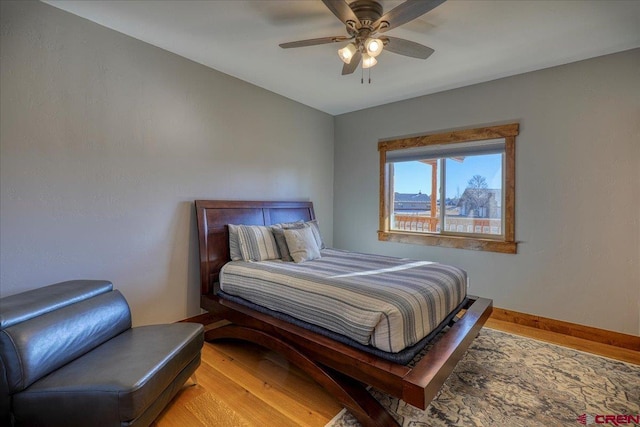 bedroom with light hardwood / wood-style floors and ceiling fan