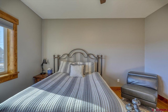 bedroom with hardwood / wood-style flooring and ceiling fan