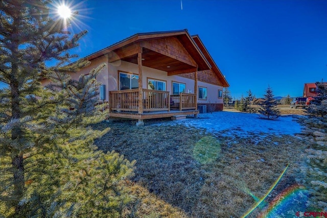 rear view of property with central AC and a wooden deck