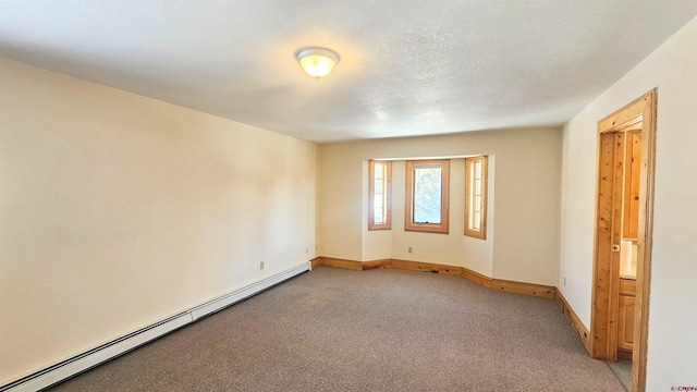 spare room with carpet floors and baseboard heating