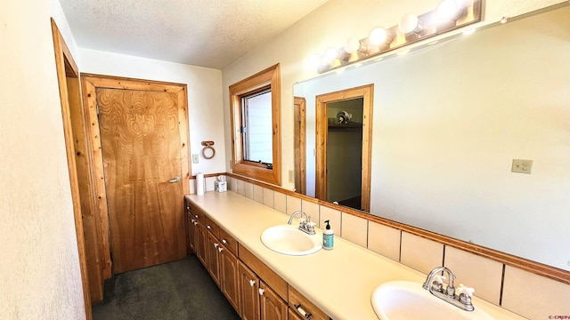 bathroom with vanity and a textured ceiling