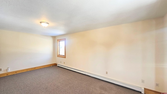 empty room featuring carpet and a baseboard radiator