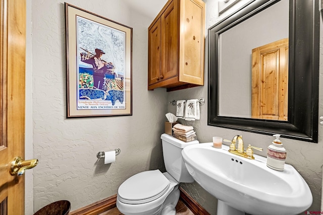 bathroom featuring sink and toilet