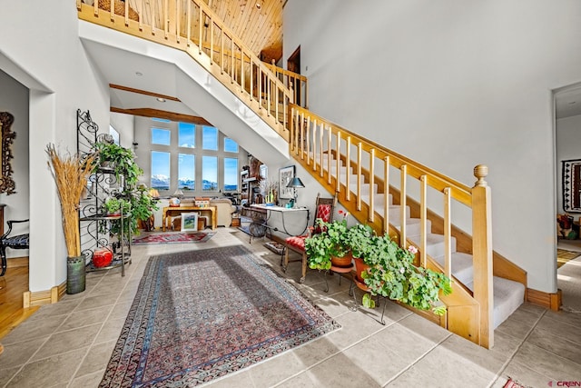 stairs featuring tile patterned floors and a high ceiling