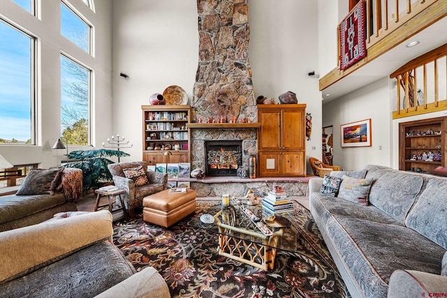 living room featuring a fireplace and a towering ceiling