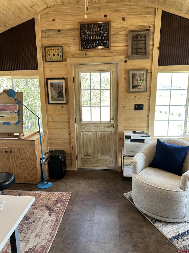 doorway to outside featuring wood walls, wooden ceiling, and vaulted ceiling