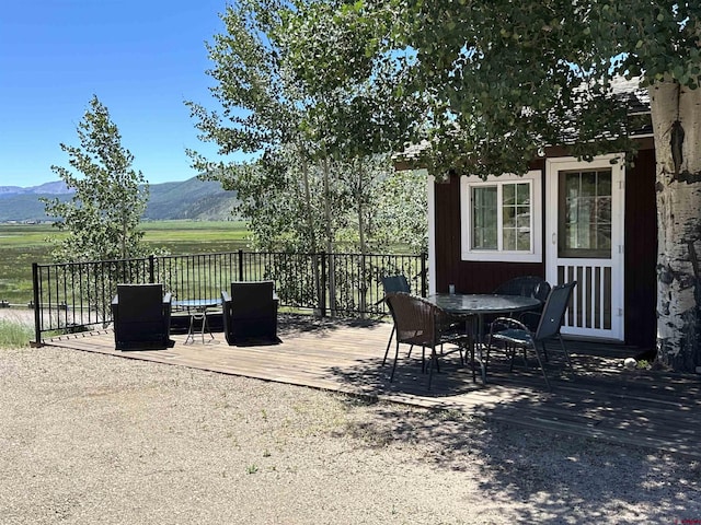 view of patio / terrace with a deck with mountain view