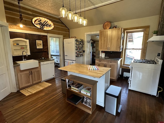 kitchen featuring sink, dark hardwood / wood-style flooring, pendant lighting, white appliances, and a kitchen island