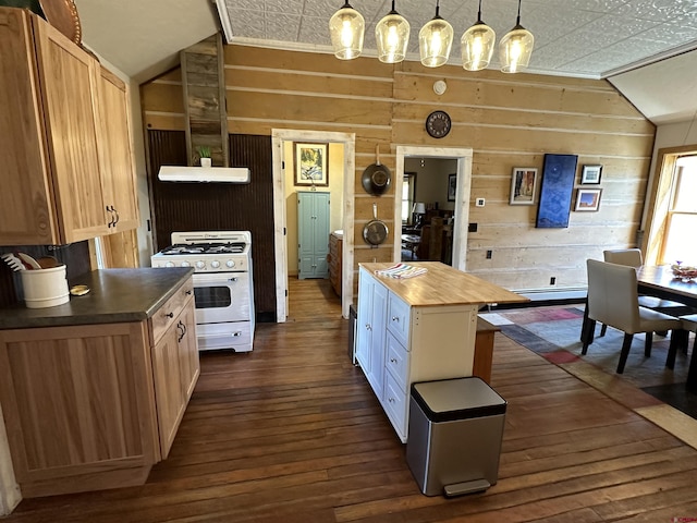 kitchen featuring dark hardwood / wood-style flooring, white gas range, a center island, butcher block countertops, and wood walls