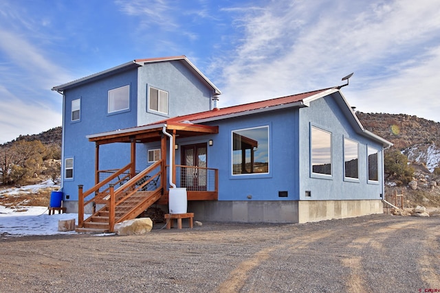 view of front of home with a mountain view and covered porch