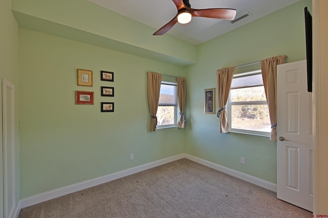 carpeted spare room with ceiling fan