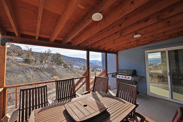 wooden terrace featuring a mountain view and grilling area