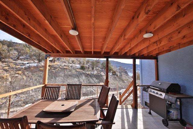 snow covered deck with a mountain view