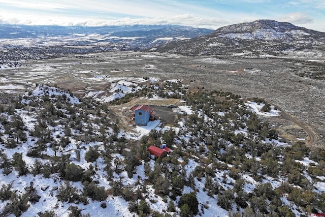 snowy aerial view featuring a mountain view