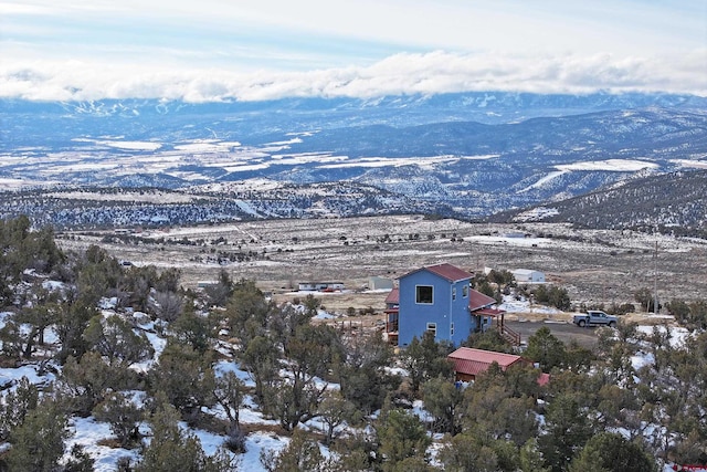 snowy aerial view with a mountain view