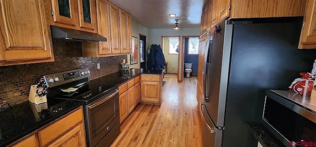 kitchen featuring tasteful backsplash, stainless steel appliances, and light hardwood / wood-style floors