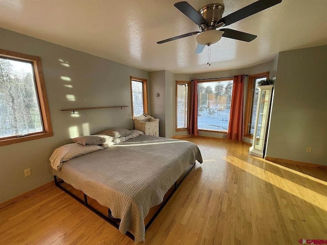 bedroom featuring ceiling fan and light hardwood / wood-style flooring