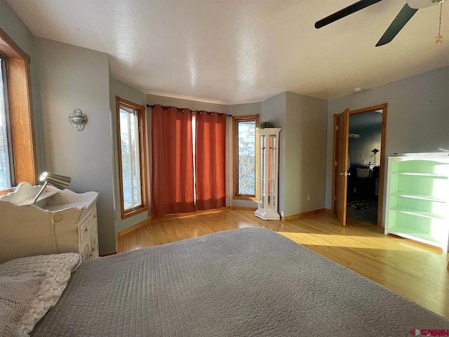 unfurnished bedroom with ceiling fan and light wood-type flooring