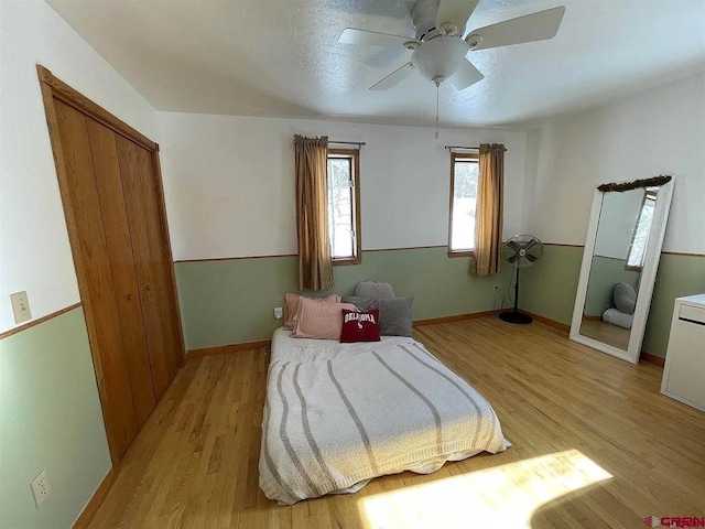 bedroom with ceiling fan and light hardwood / wood-style floors