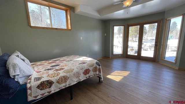 bedroom with ceiling fan, access to outside, french doors, and hardwood / wood-style flooring