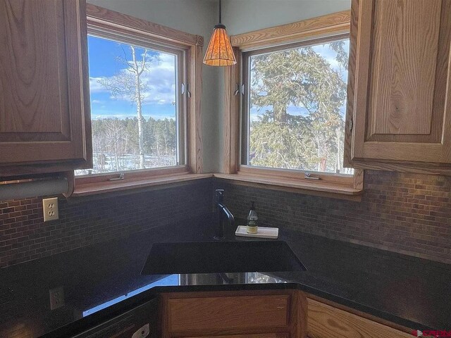 kitchen featuring decorative backsplash, sink, and plenty of natural light