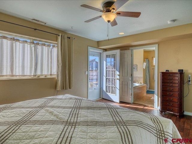 unfurnished bedroom featuring multiple windows, wood-type flooring, ensuite bath, and ceiling fan