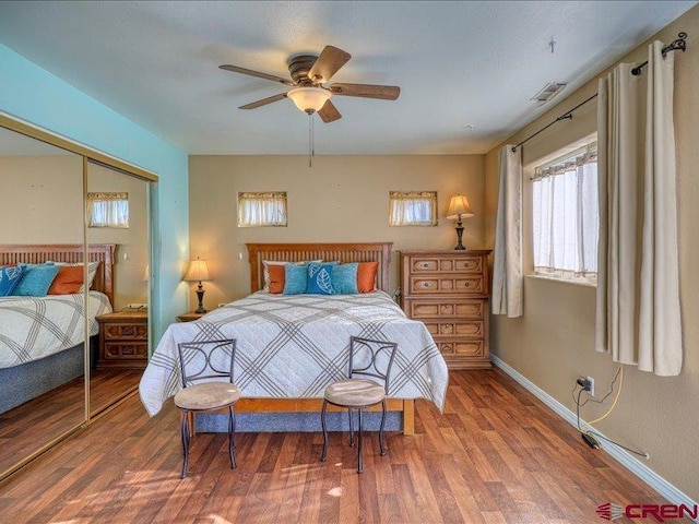 bedroom featuring wood-type flooring, a closet, and ceiling fan