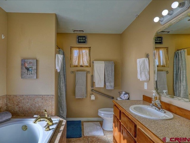 bathroom featuring tile patterned flooring, vanity, toilet, and tiled tub