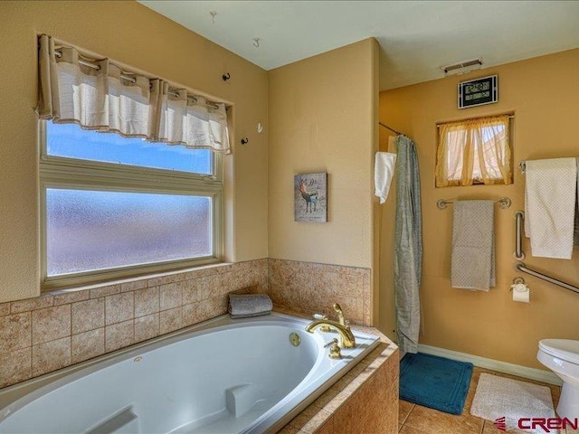 bathroom featuring tile patterned flooring, plus walk in shower, plenty of natural light, and toilet