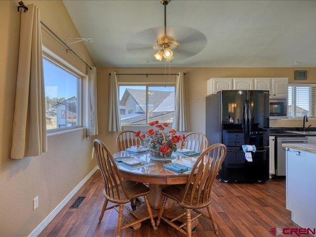 dining area featuring ceiling fan, dark hardwood / wood-style flooring, and sink